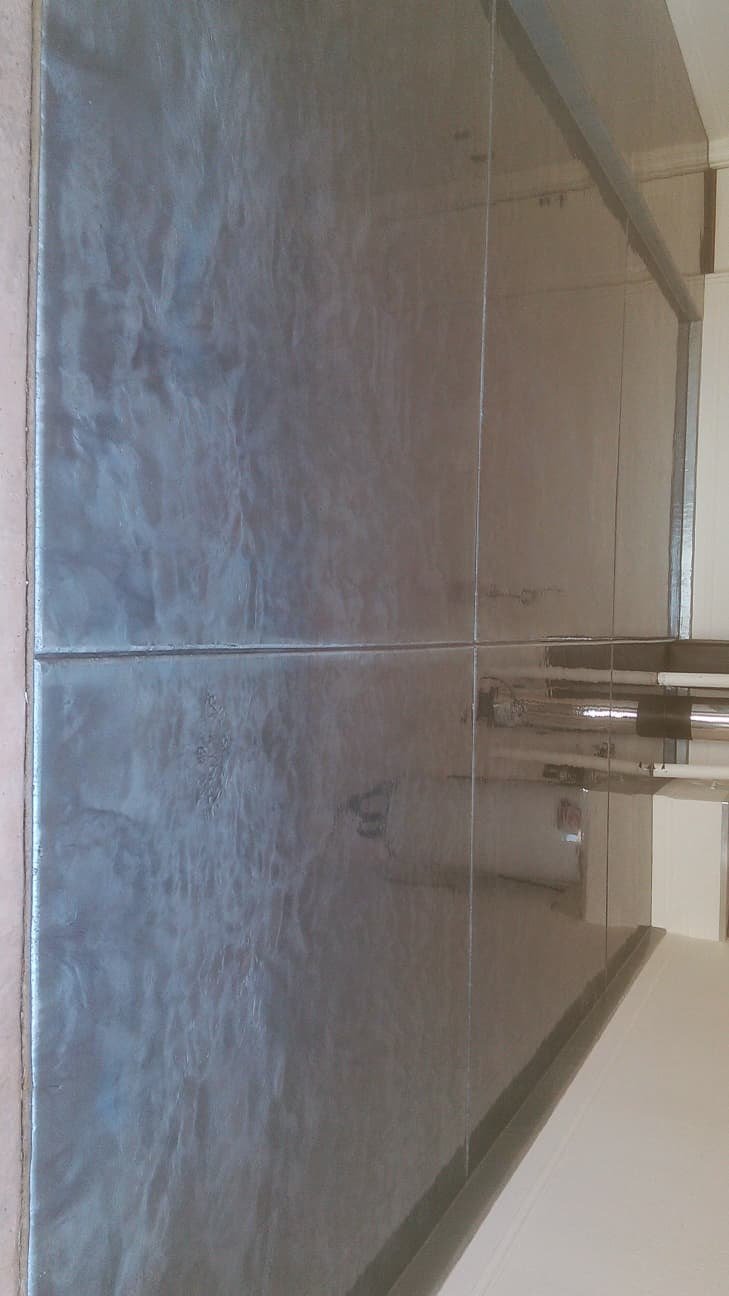 Grey metallic epoxy floor with a glossy marbled finish