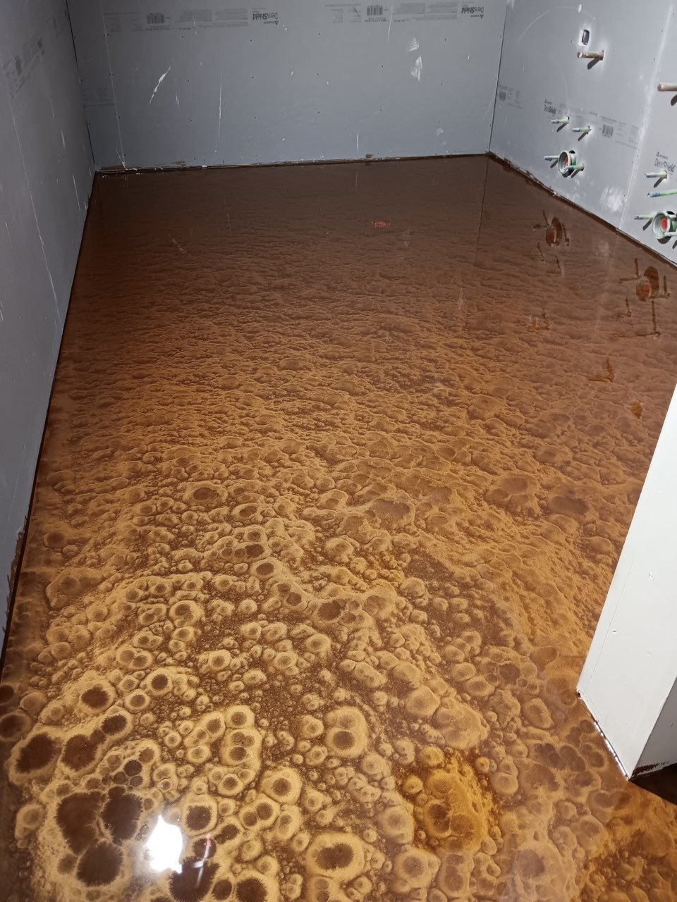 Copper metallic epoxy floor with a marbled pattern