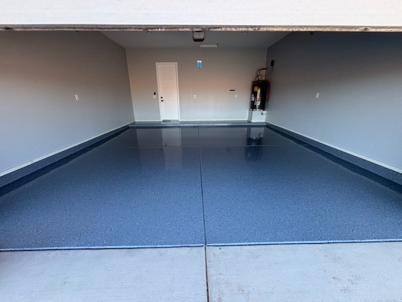 Blue-grey flake epoxy garage floor with the garage door open