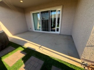 Covered patio concrete slab next to artificial turf
