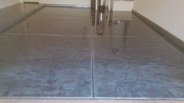Grey metallic epoxy floor with a glossy marbled finish