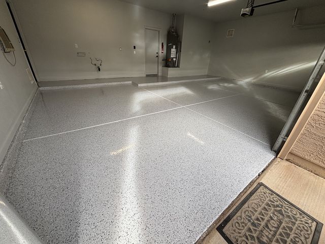 Light grey flake epoxy garage floor with a high-gloss finish