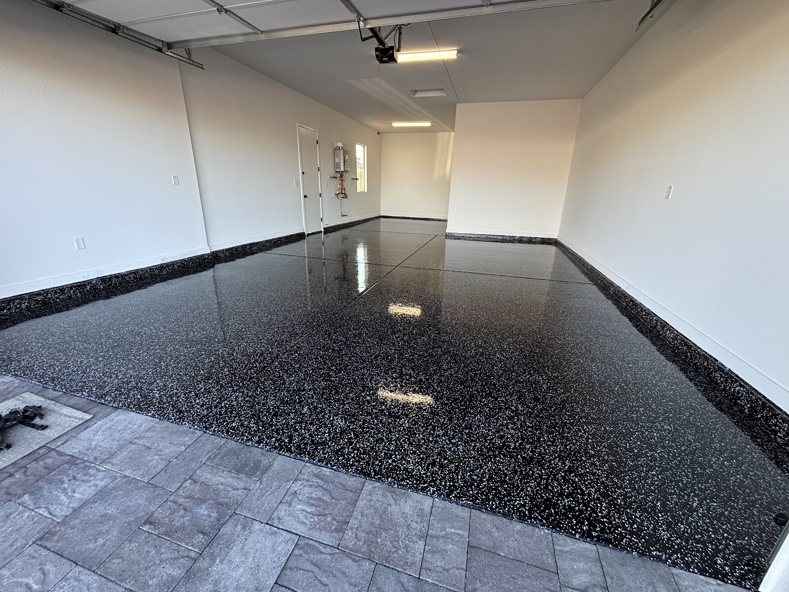 Glossy black flake epoxy floor in a two-car garage