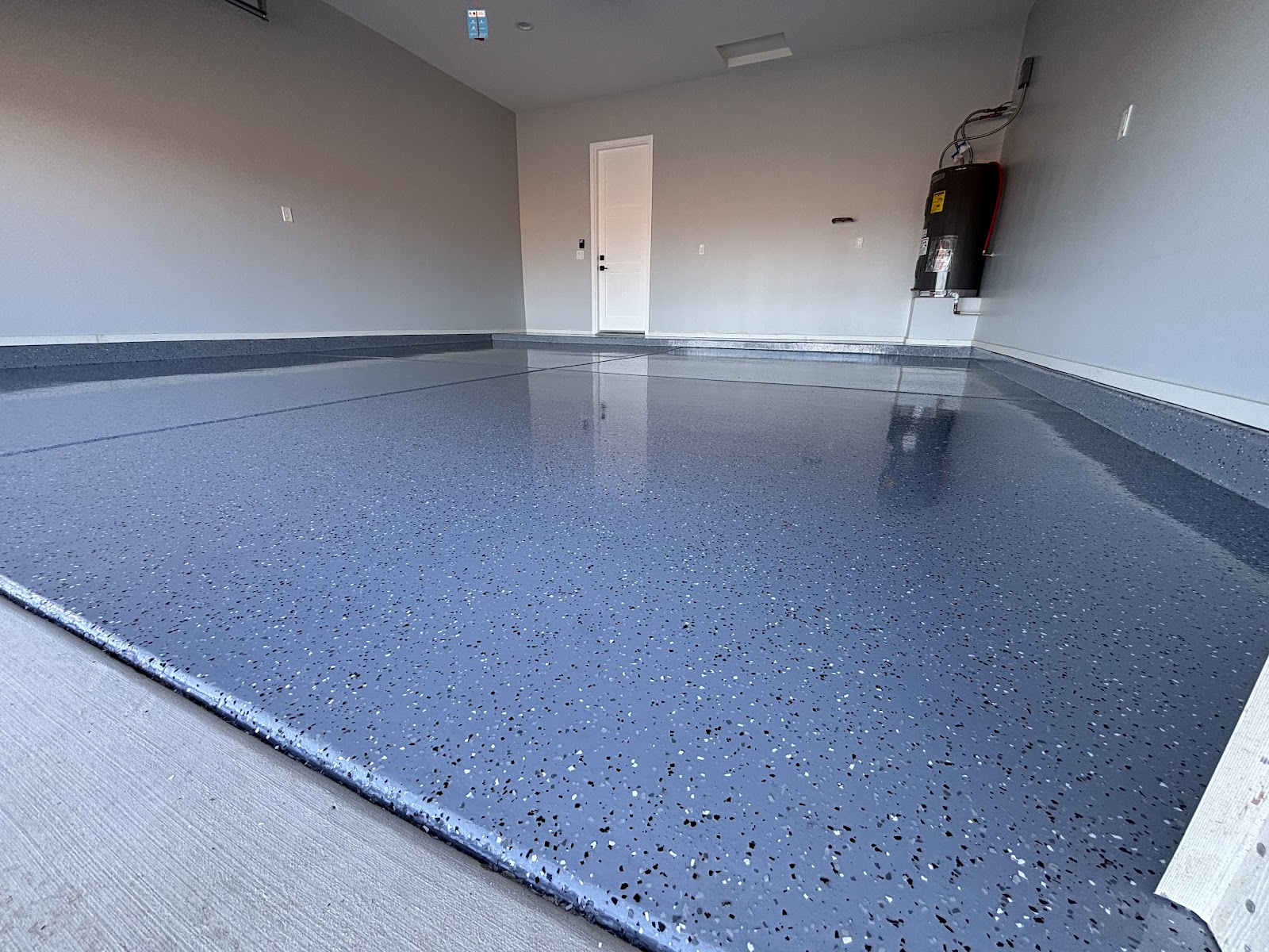 Close view of a blue-grey flake epoxy garage floor
