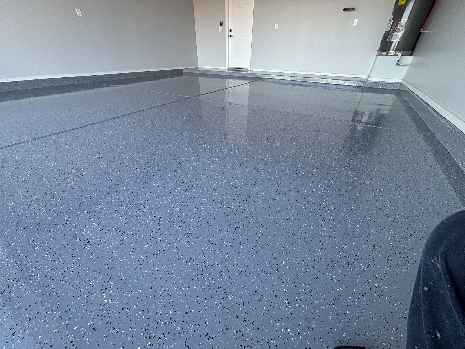 Wide view of a blue-grey flake epoxy garage floor