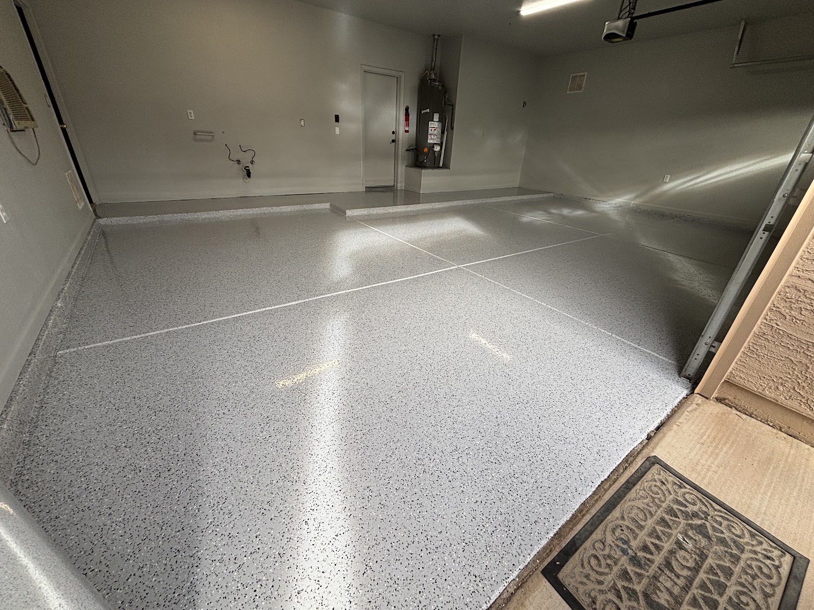 Light grey flake epoxy garage floor with a high-gloss finish